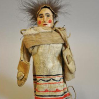 Wooden Doll Wearing Painted Hide Strap Dress